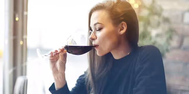 a person drinking wine