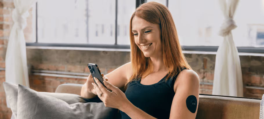 a woman with a CGM patch using a diet app