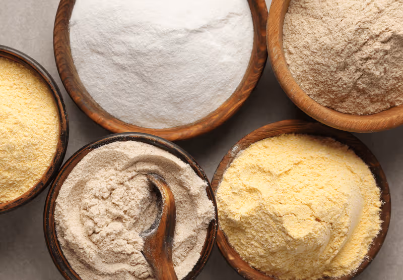 five bowls with different types of gluten-free flour