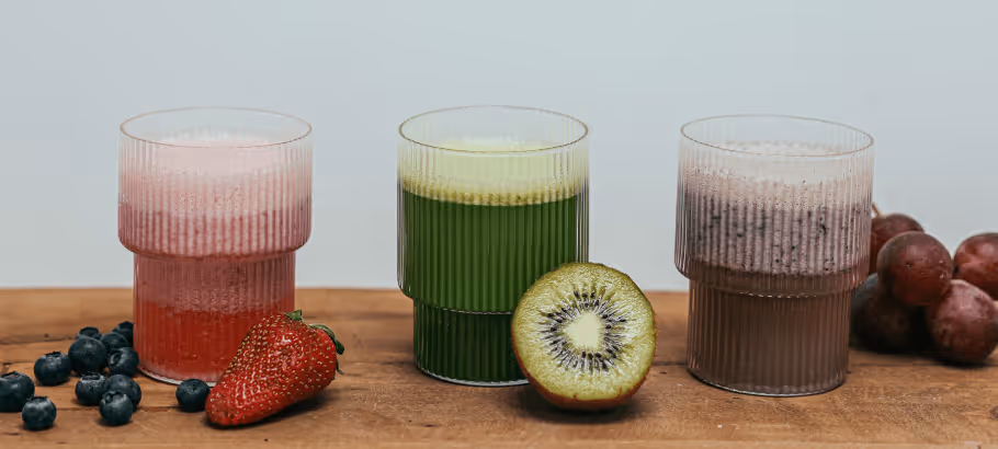 glasses of fruit juice and fresh fruit