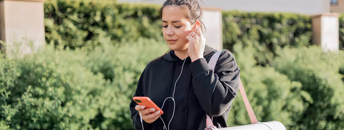 a person listening to something through headphones outdoors