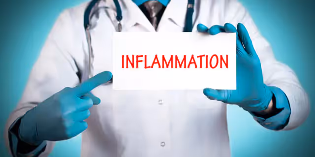 a doctor a sign that says "Inflammation"