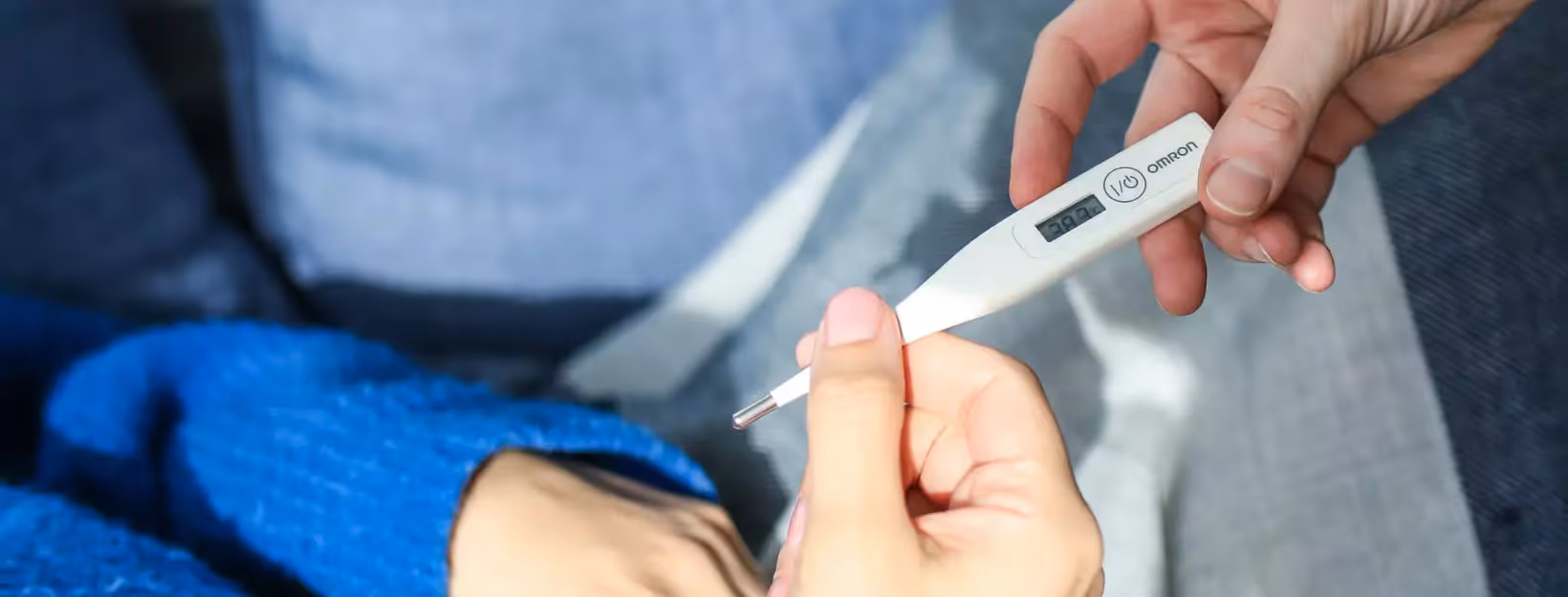 a person measuring their body temperature