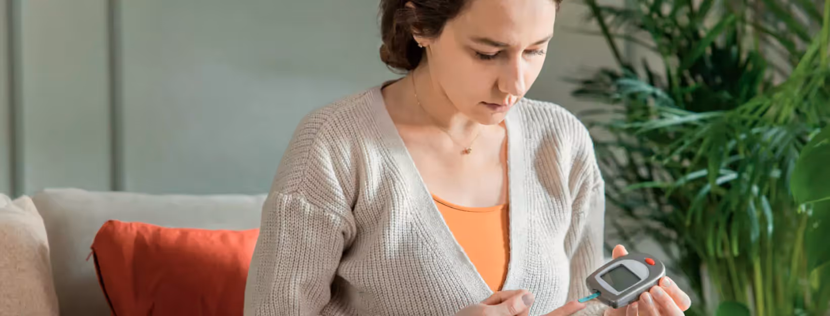 a person using finger prick method to test glucose level