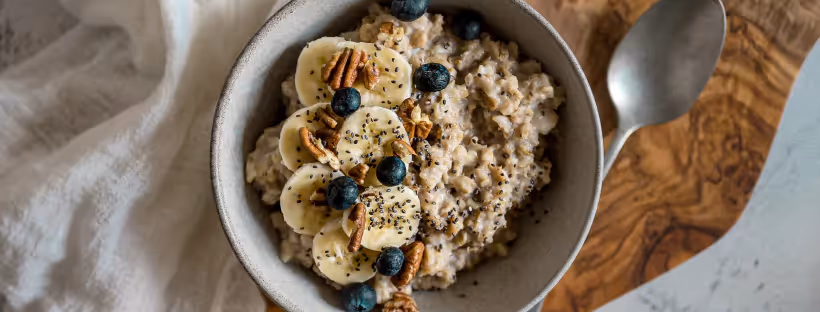 A bowl of chia seed pudding topped with bananas, blueberries and sliced bananas