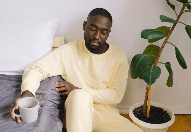 a man sitting on the couch and looking sad