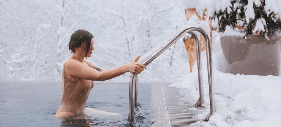 a woman getting out of a cold bath