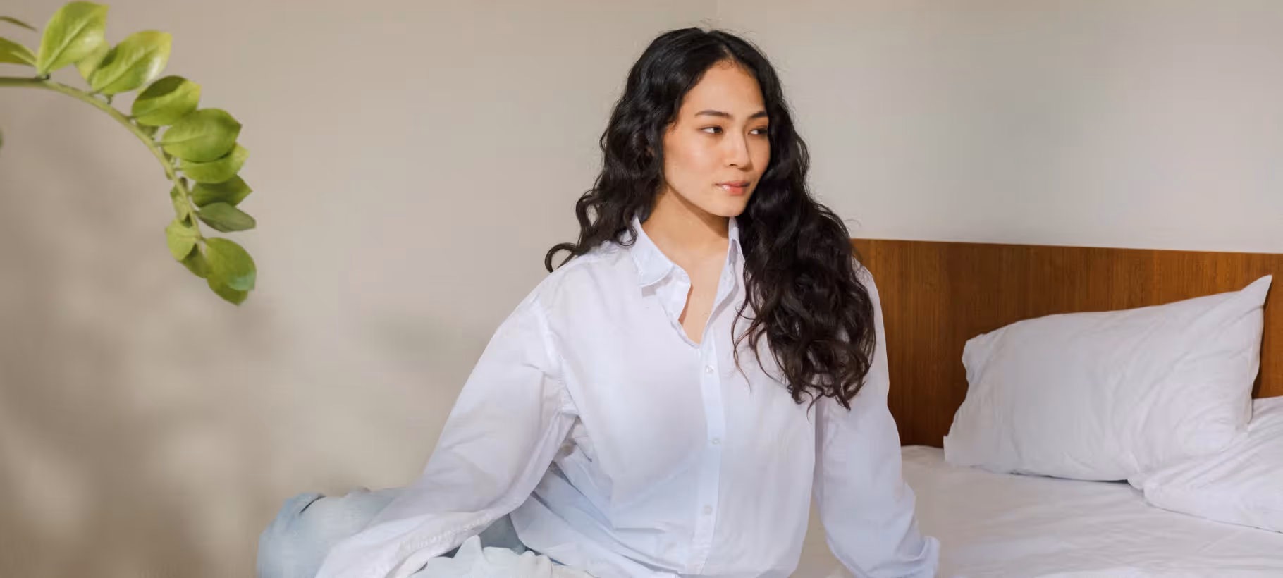 a woman sitting on her bed