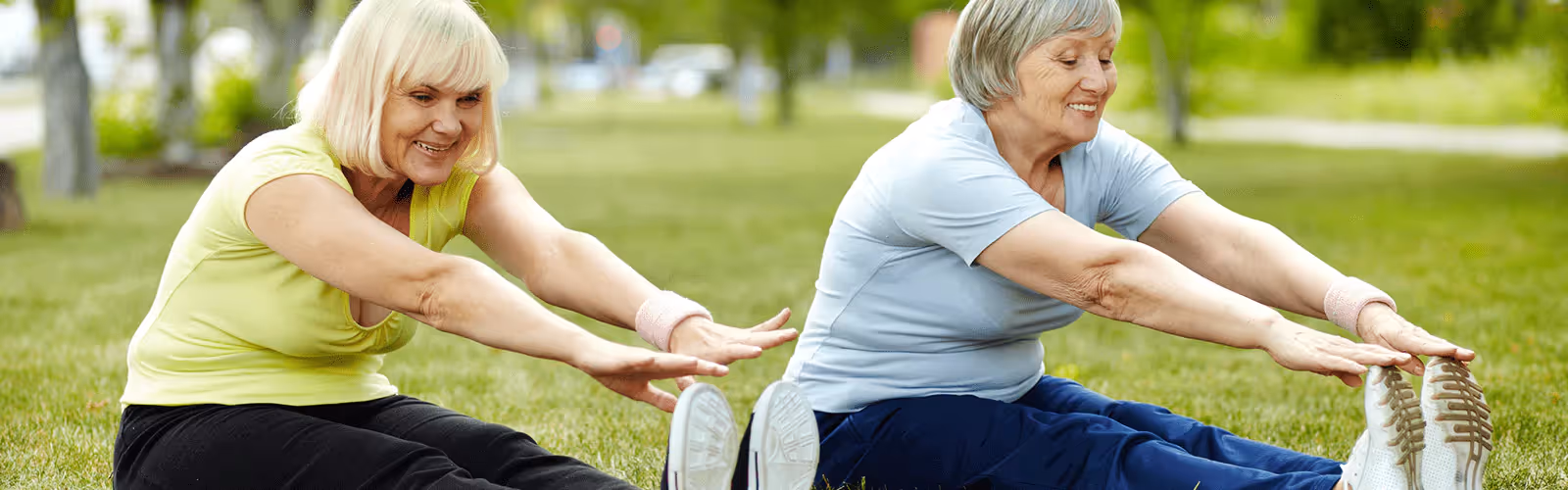 two people stretching outdoors