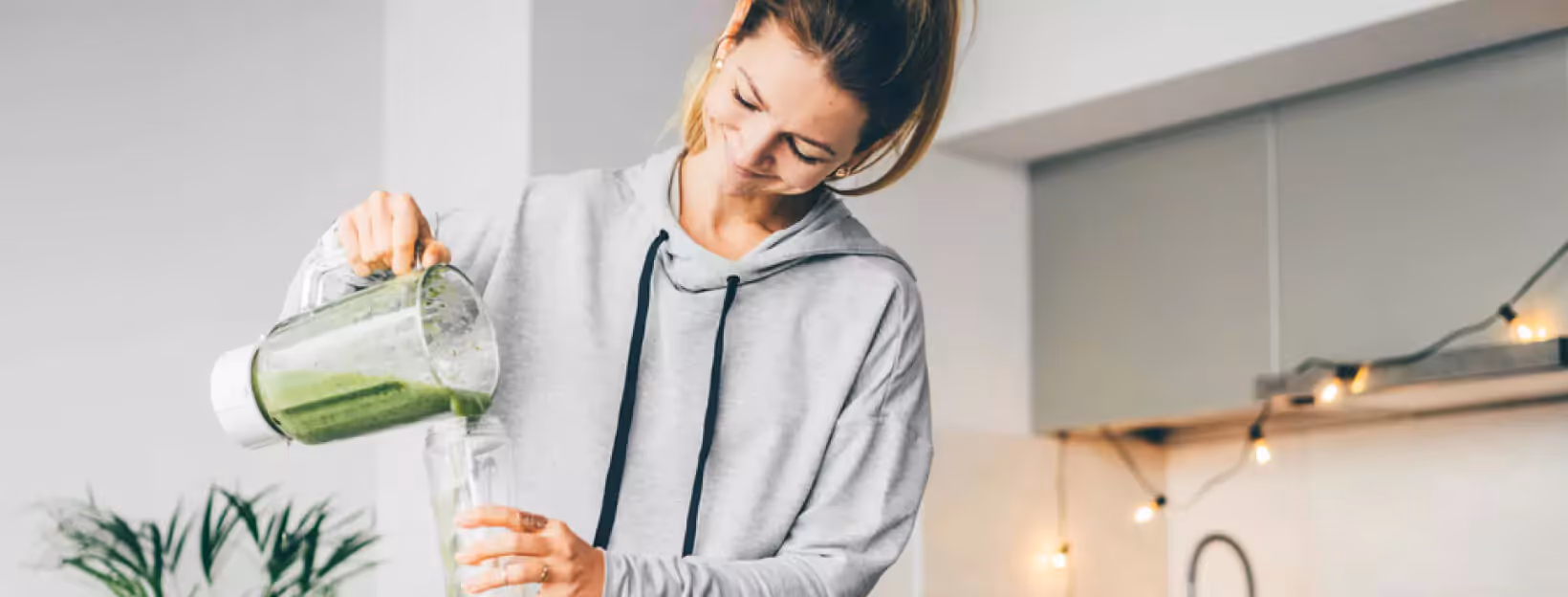 a person making a green smoothie
