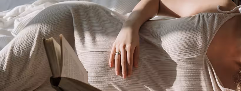 A woman lying down on her side holding her stomach