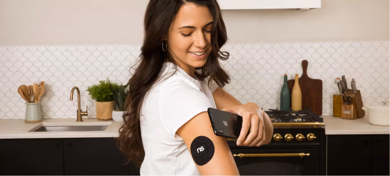 a person scanning their nutrisense cgm