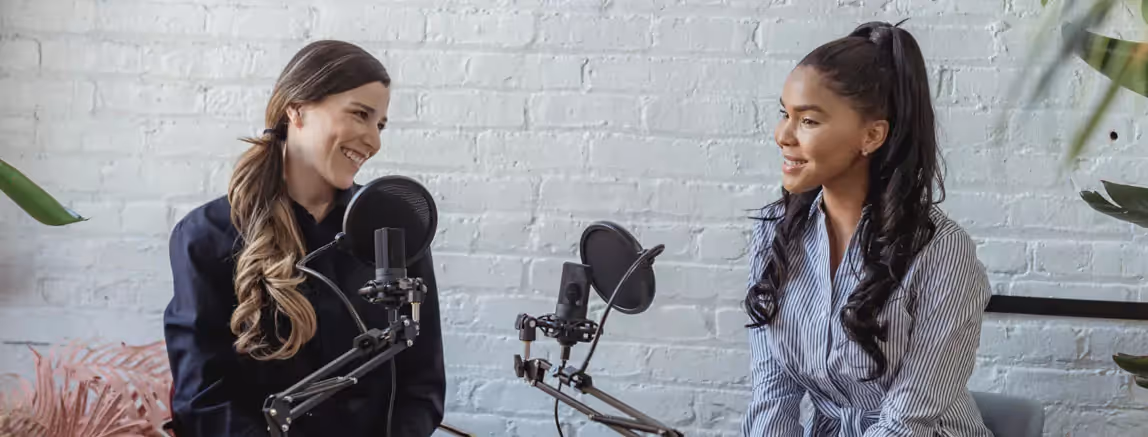 two people speaking into the microphone