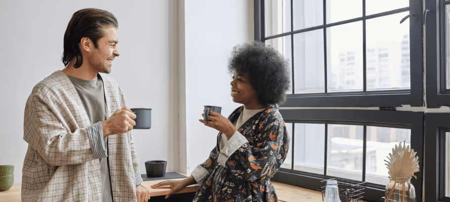 two people laughing over a coffee