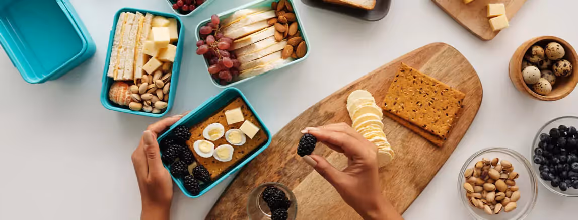 a person preparing lunchboxes
