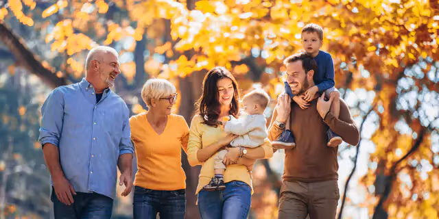 three generation of a family walking and laughing