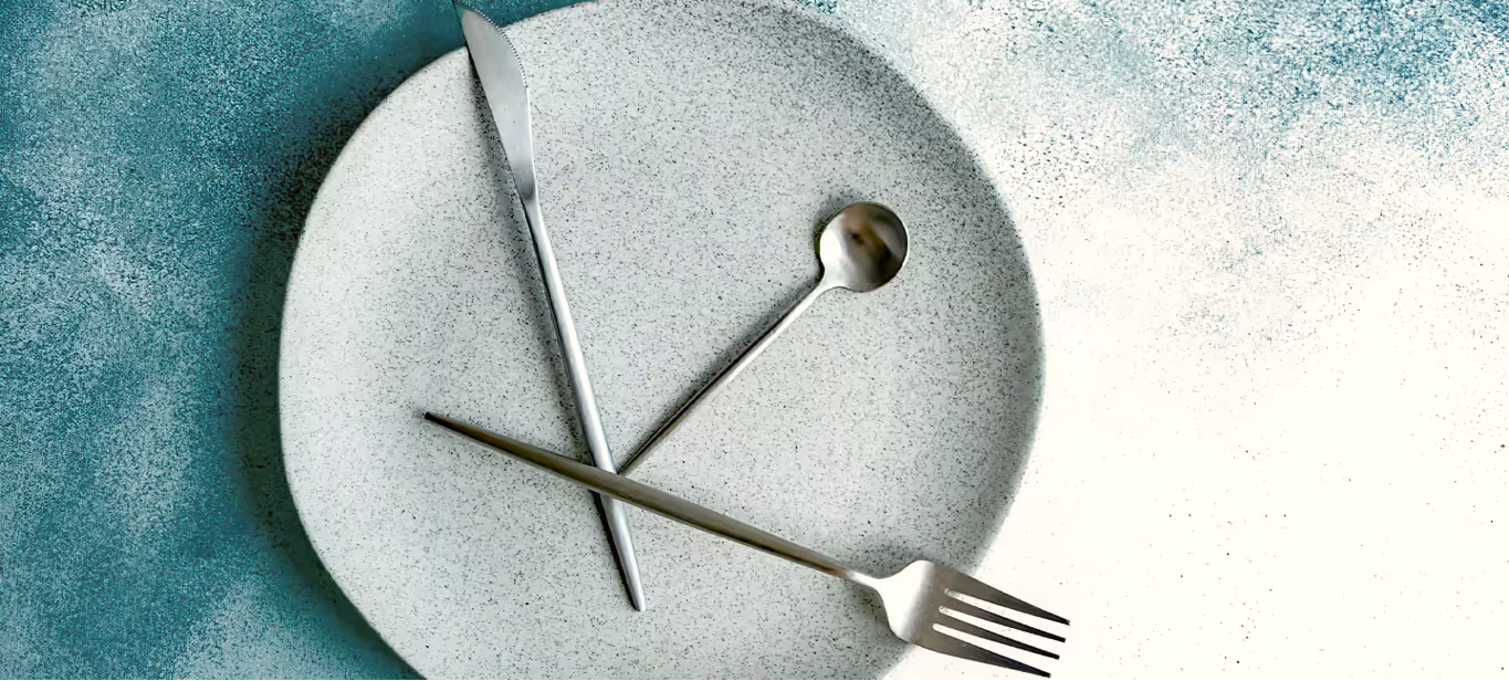 an empty plate with cutlery on top