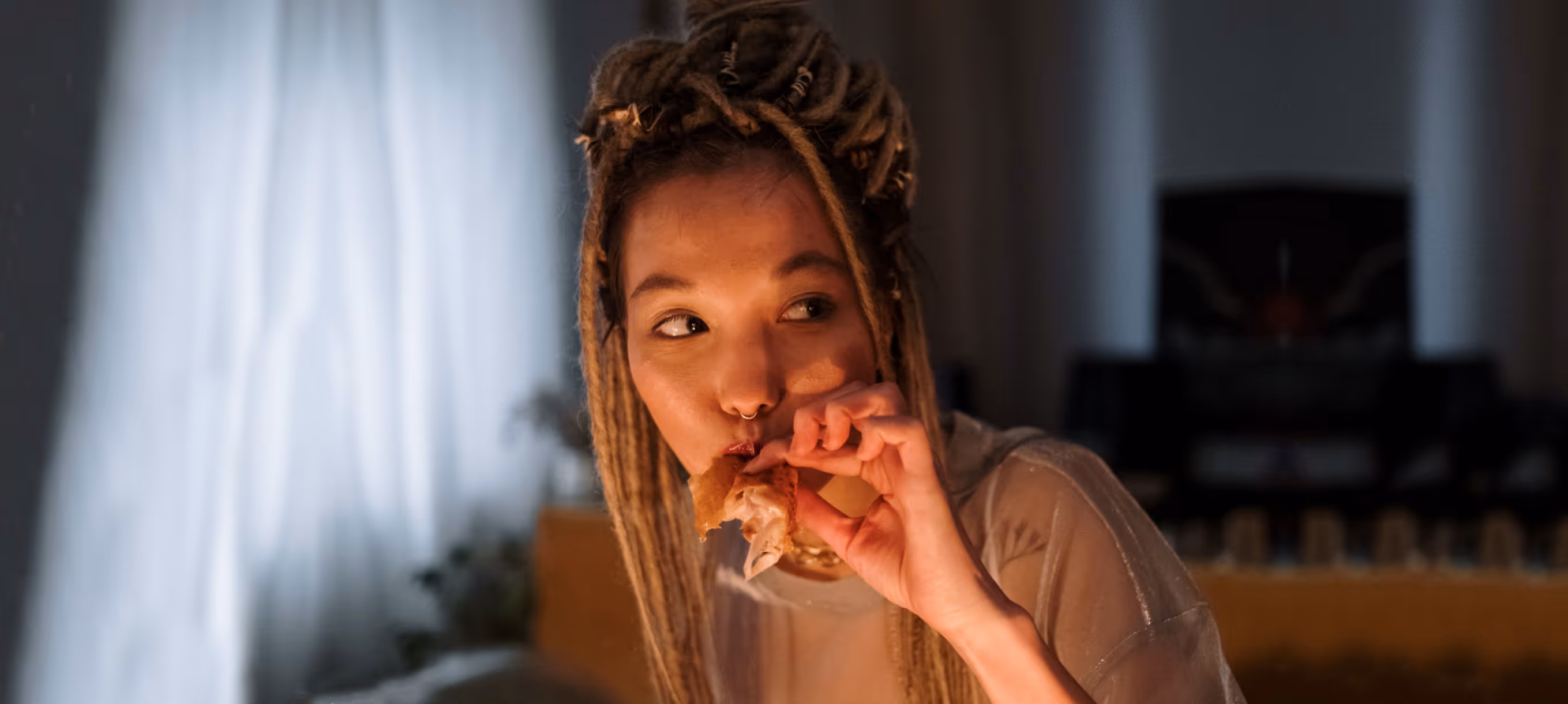 a girl eating food at night