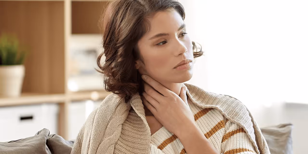 a person touching their neck