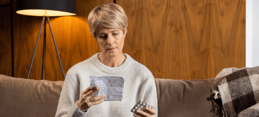 an older woman looking at medicine instructions