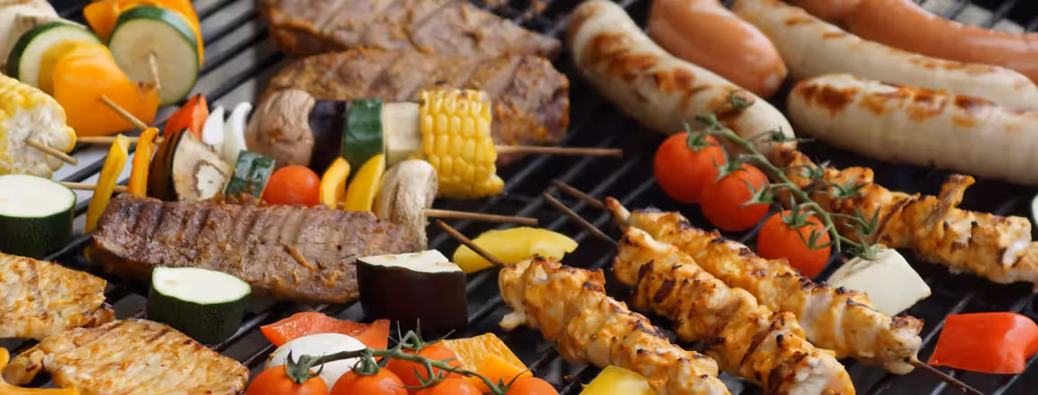 meat, veggies and sauces being grilled