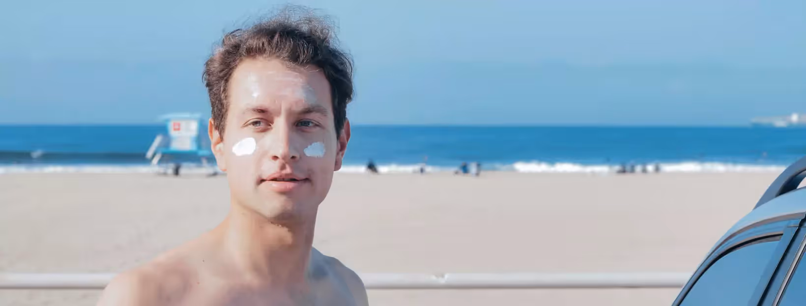 a person at the beach with sunscreen applied