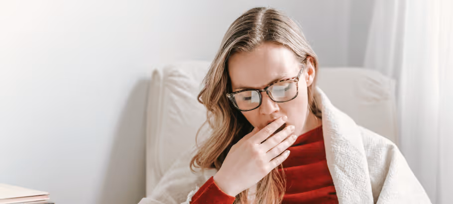 a woman yawning in her home