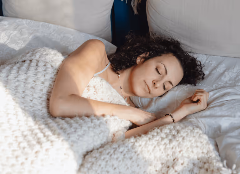 A woman sleeping in her bed