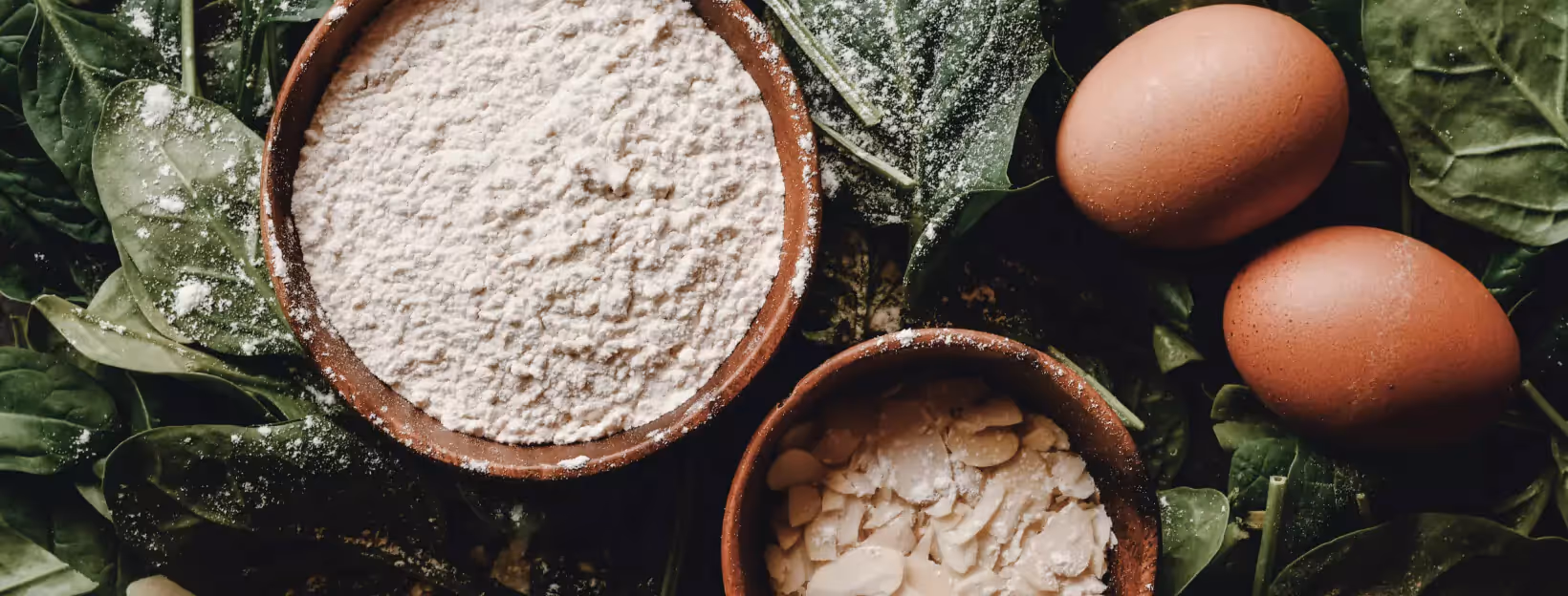 two eggs and a bowl of flour