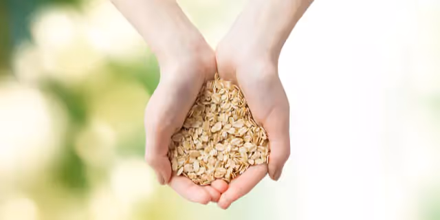 someone holding oat flakes on their palms