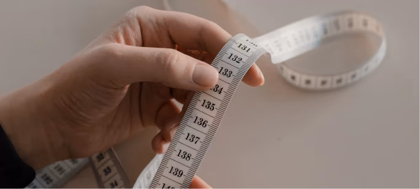 someone holding a measuring tape