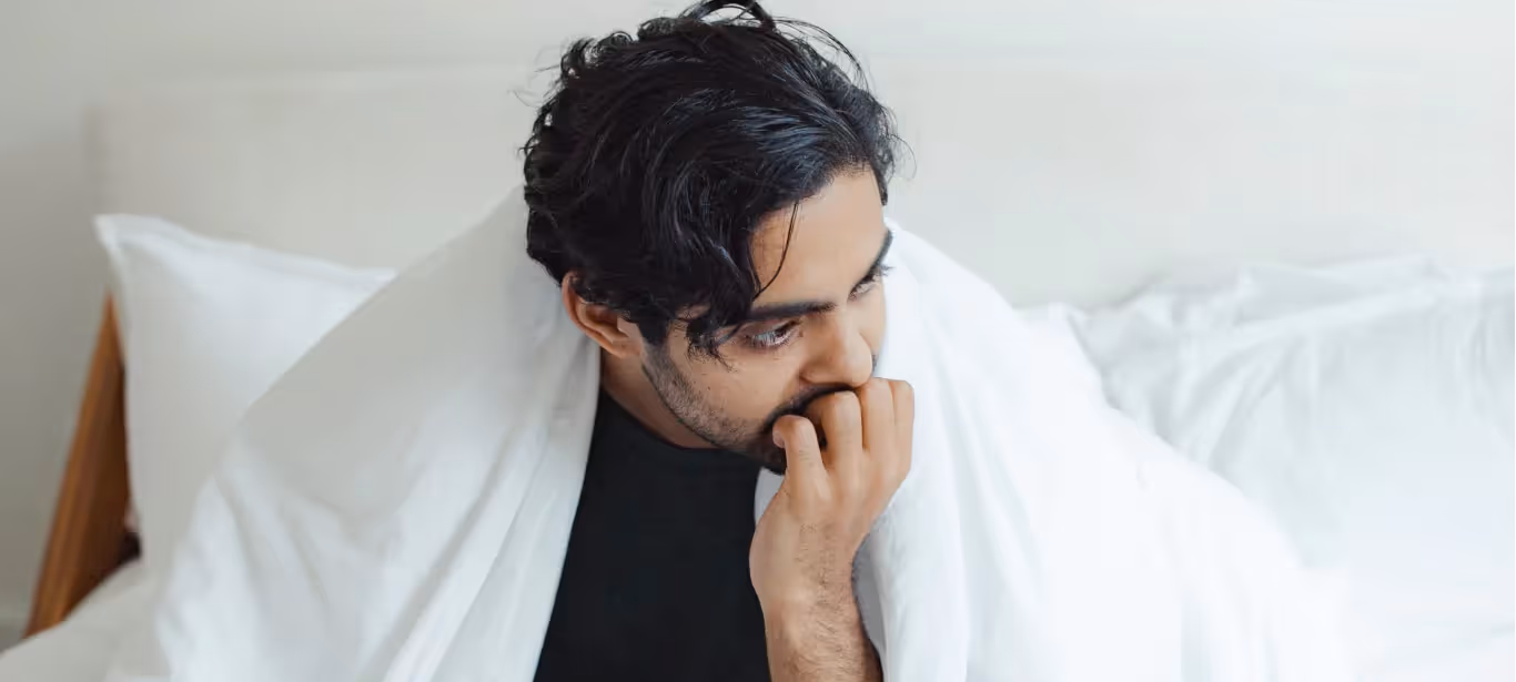 a boy in bed feeling stressed