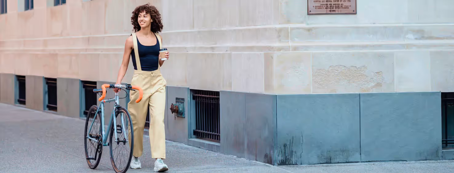 a person walking and drinking a coffee