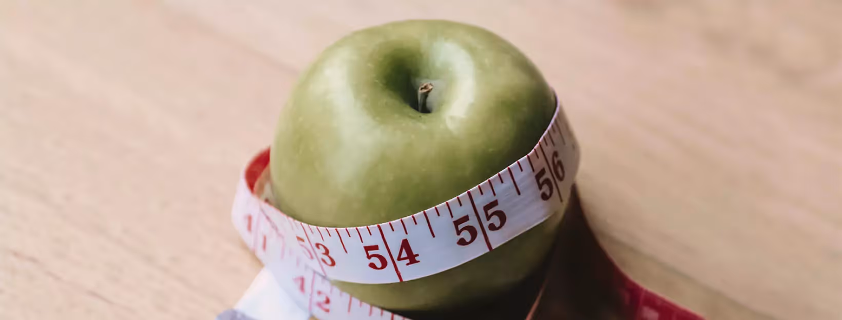 an apple covering with tape measure