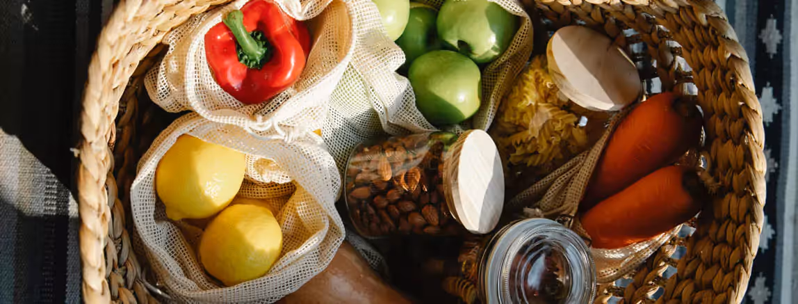a basket of fruits, vegetables and pasta