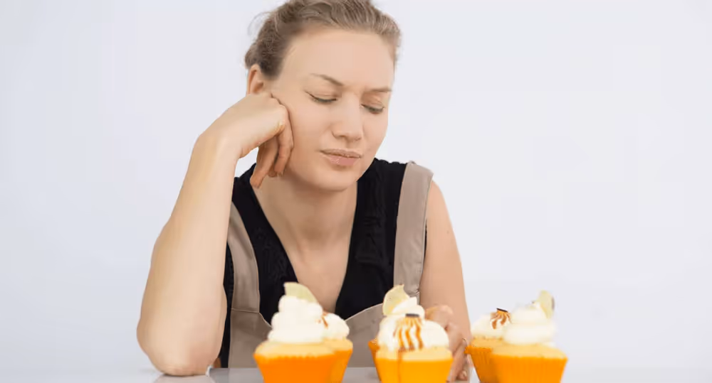 a person eating muffins looking irritated