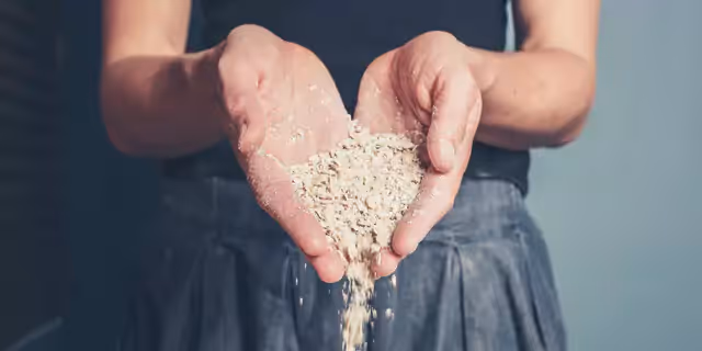 a person holding oat flakes on their palms