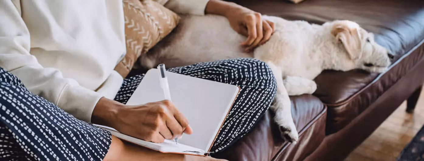 a person writing down in their notebook