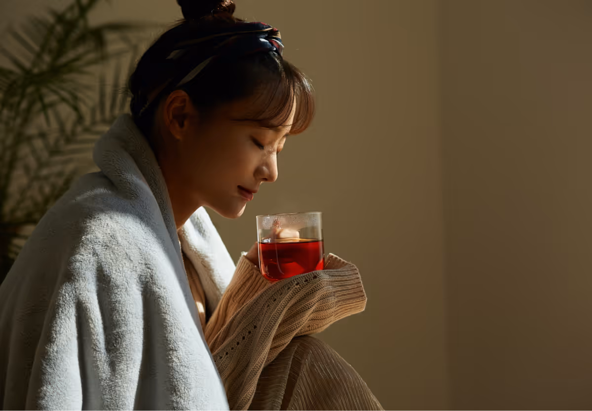 a girl with a cup of hot tea