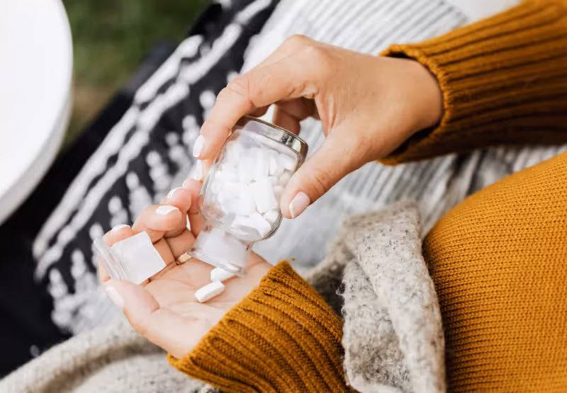 someone with a bottle of iron supplements