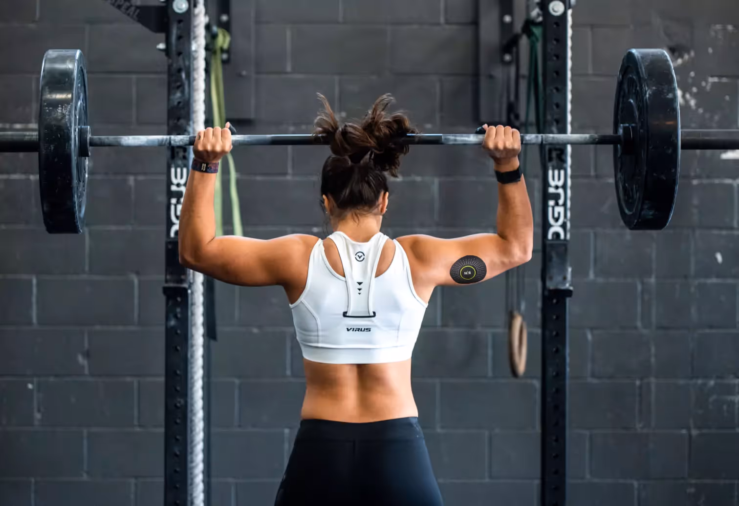 someone lifting barbell with a CGM