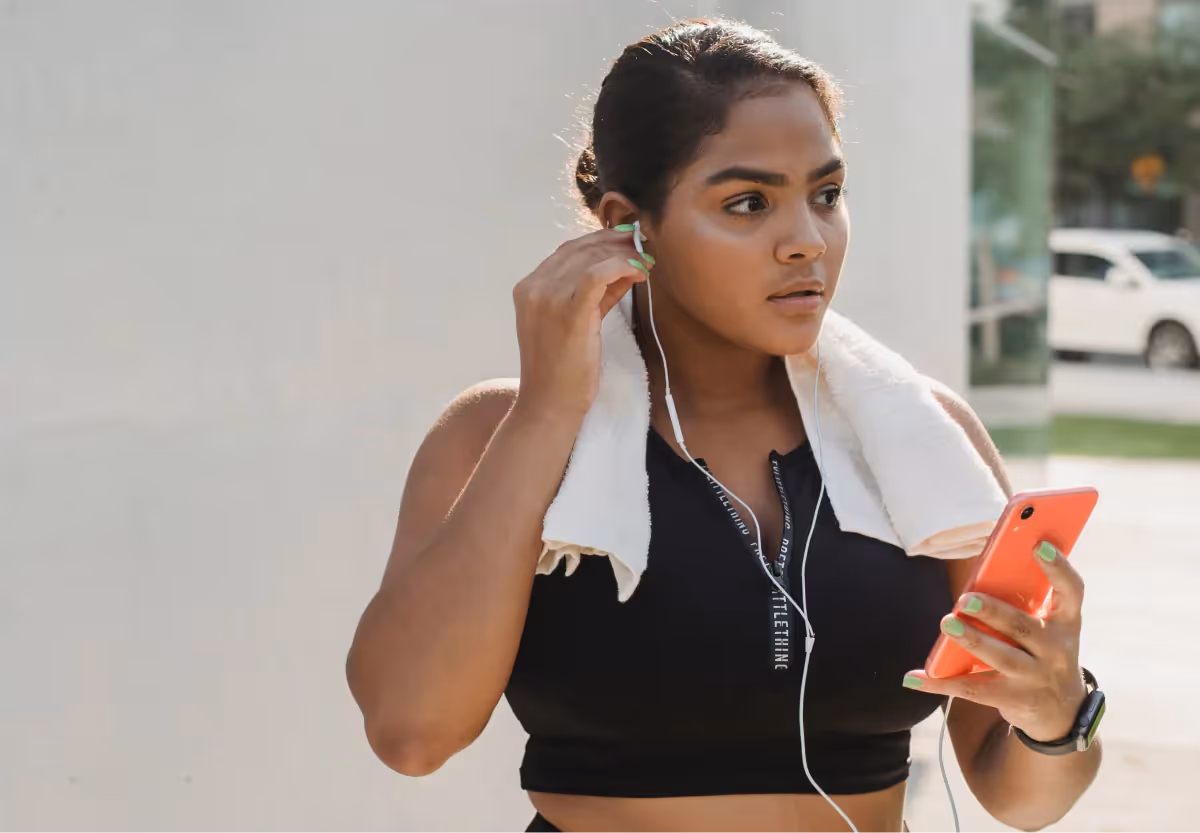 a woman in workout clothes using an app