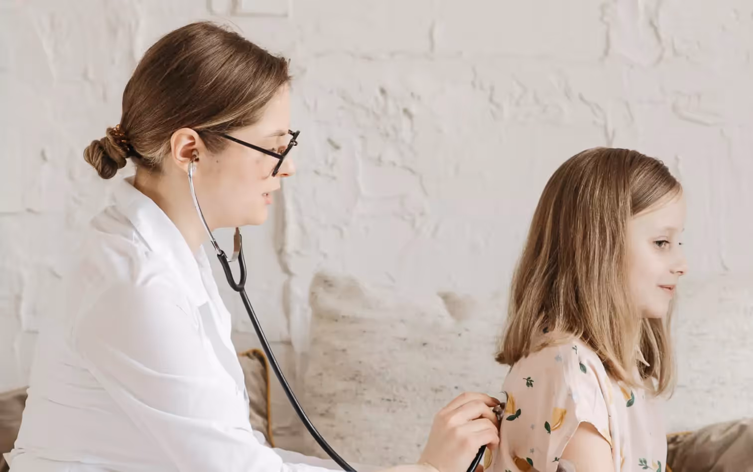 a doctor checking kid's breathing 
