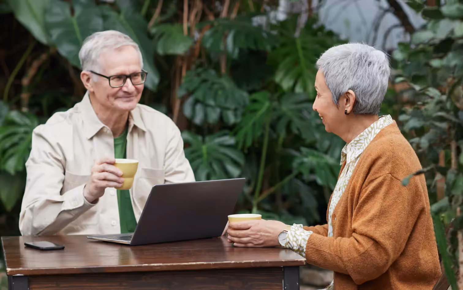 a couple of older people having drinks