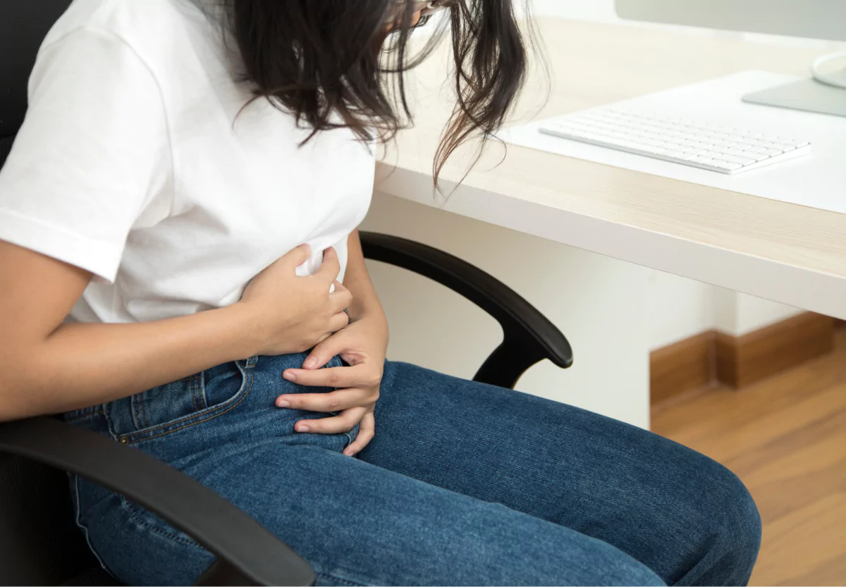 a girl holding her stomach in pain