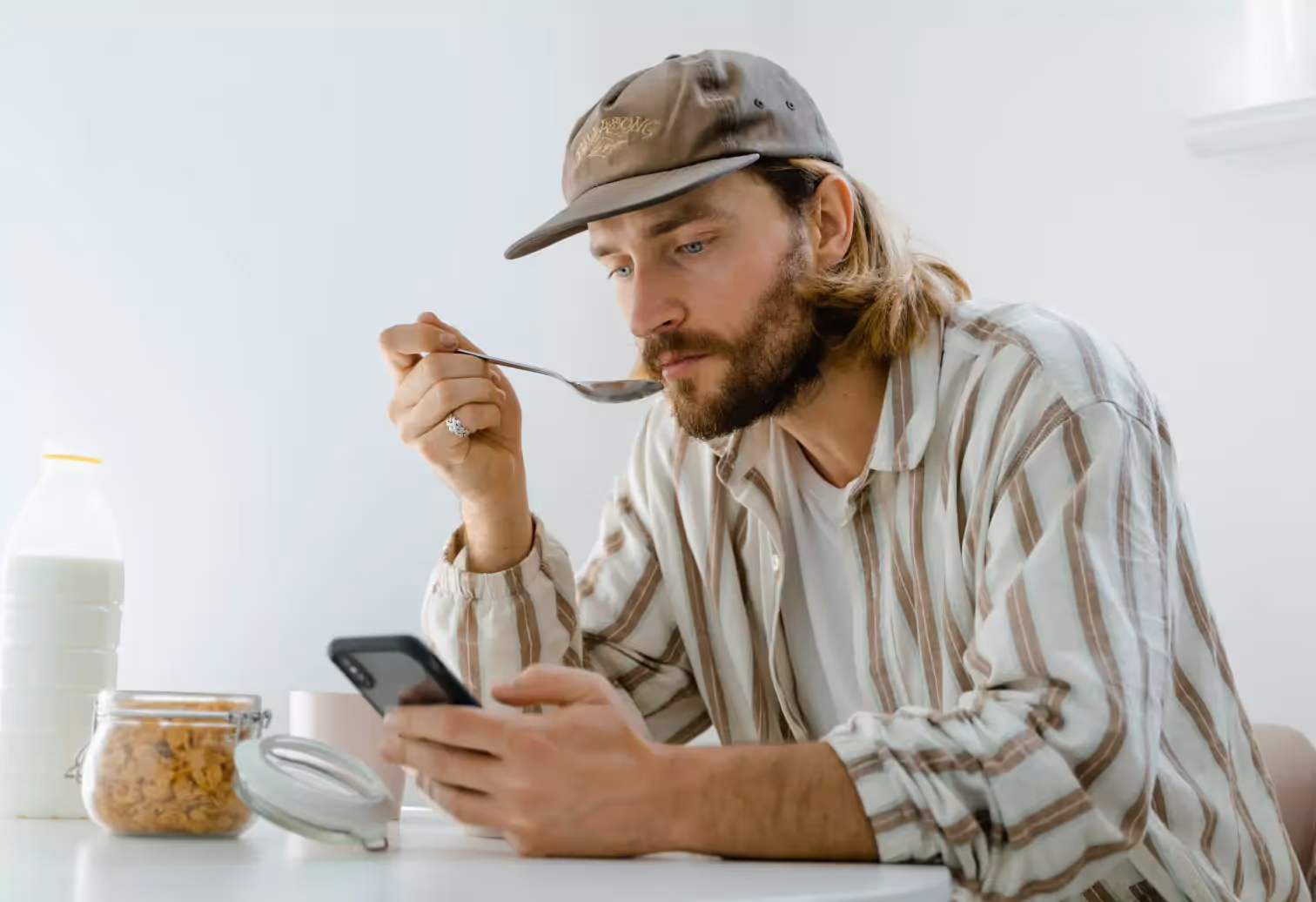 a man eating and looking at his phone