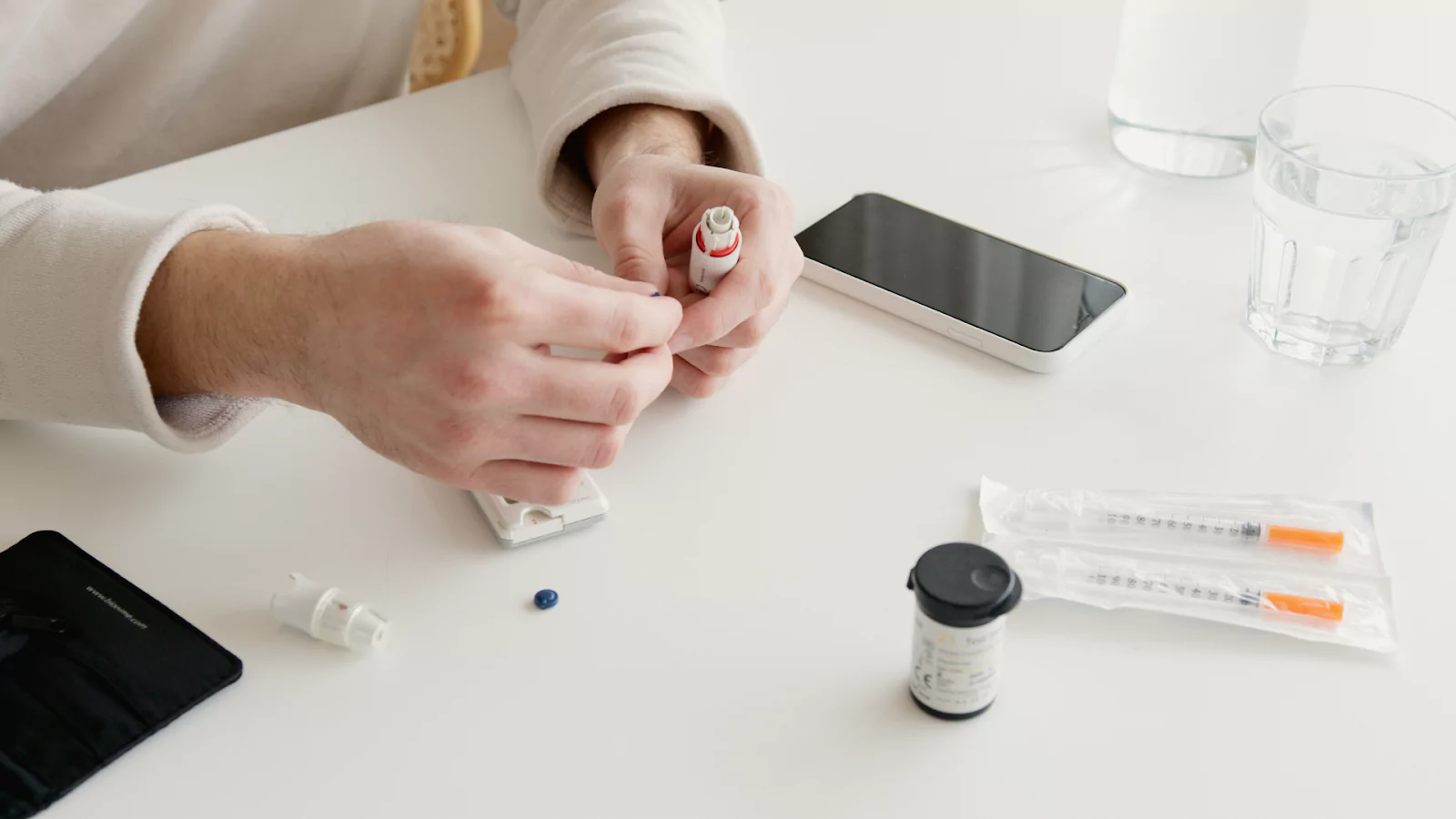 Someone using a glucose monitor