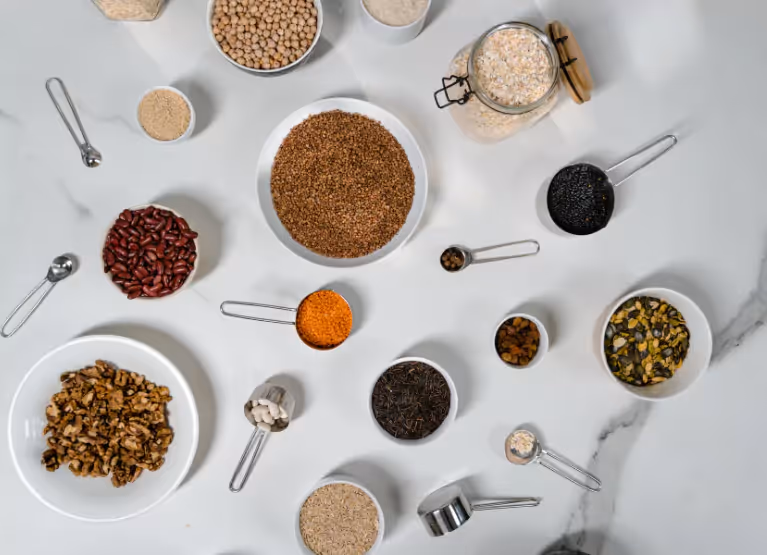 A table with bowls of whole grains and legumes