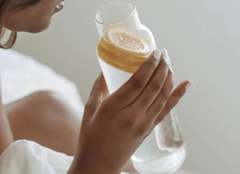 Person drinking lemon water