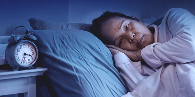 a person laying in bed with their eyes opened